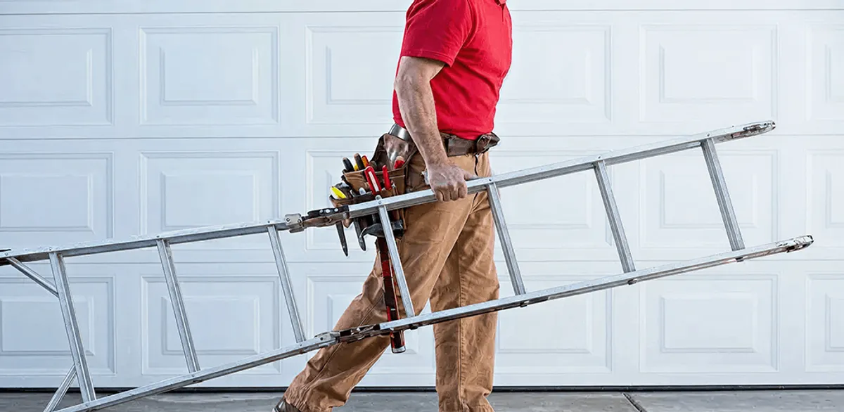 Garage door repair technician arriving with tools and ladder in Anchorage, AK