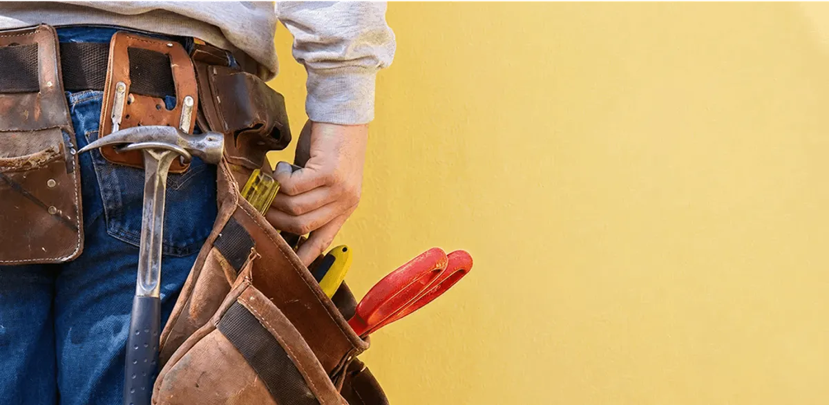 Handyman with tool belt ready for home repairs and maintenance in Anchorage, AK