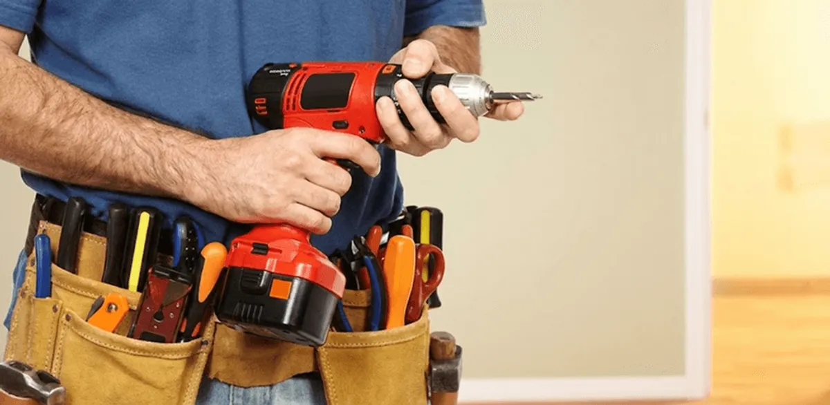 Handyman holding a power drill for home repairs and installations in Anchorage, AK