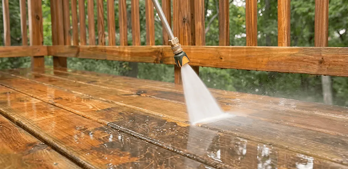 Pressure washing a wood deck to remove dirt and buildup in Anchorage, AK