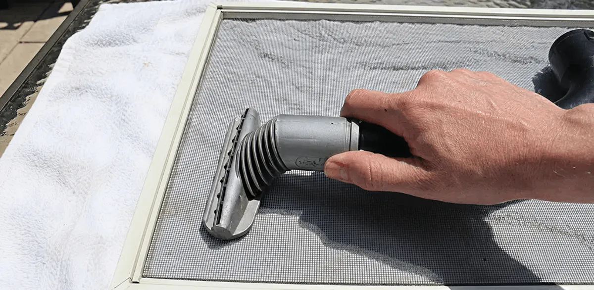 Window screen repair cleaning and fixing a damaged screen mesh in Anchorage, AK