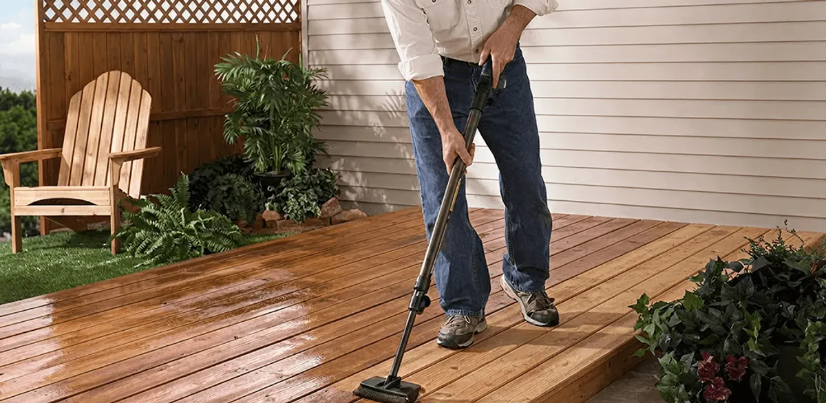 Deck staining service applying stain to a backyard wood deck in Anchorage, AK